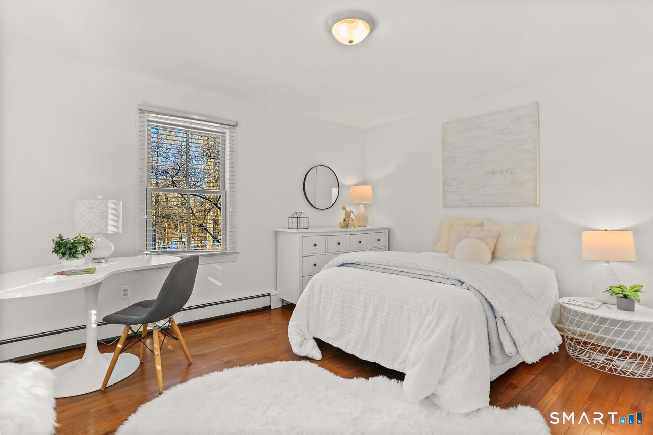 103 Davis Hill Road Weston, CT 06883 - Photo 23 of 37 a bed room with a bed and a chair