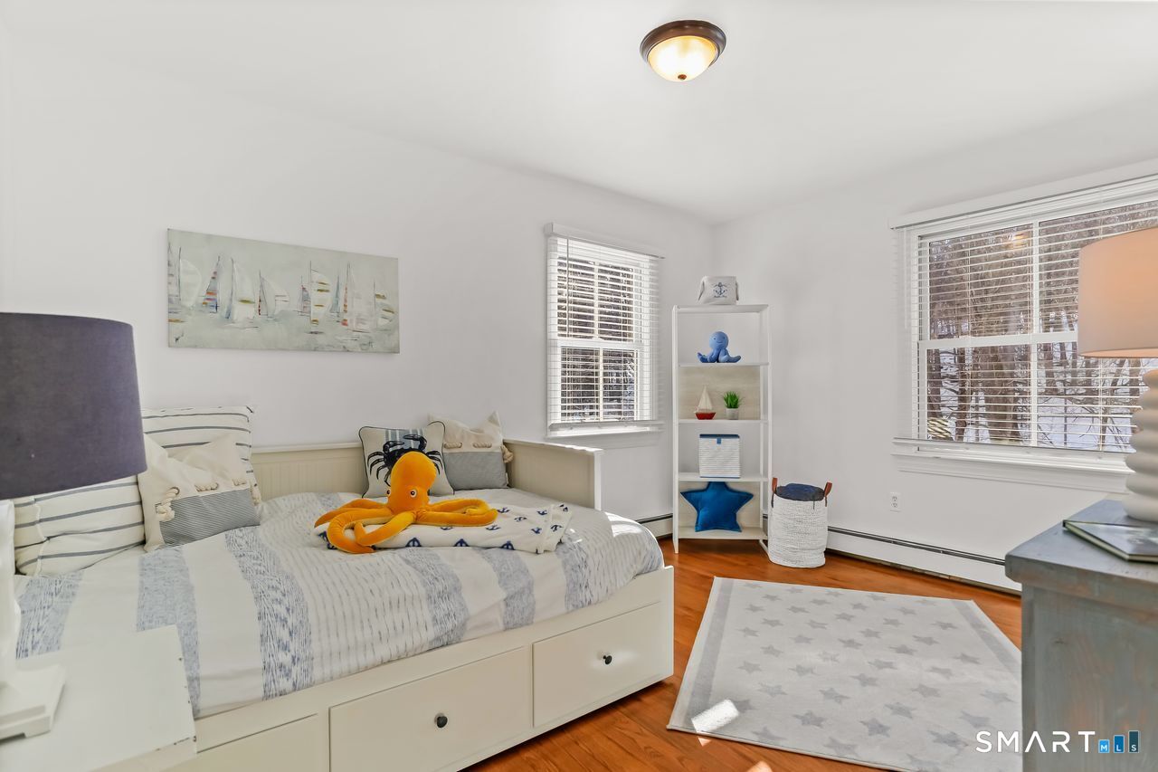 103 Davis Hill Road Weston, CT 06883 - Photo 24 of 37 a bedroom with a bed and wooden floor