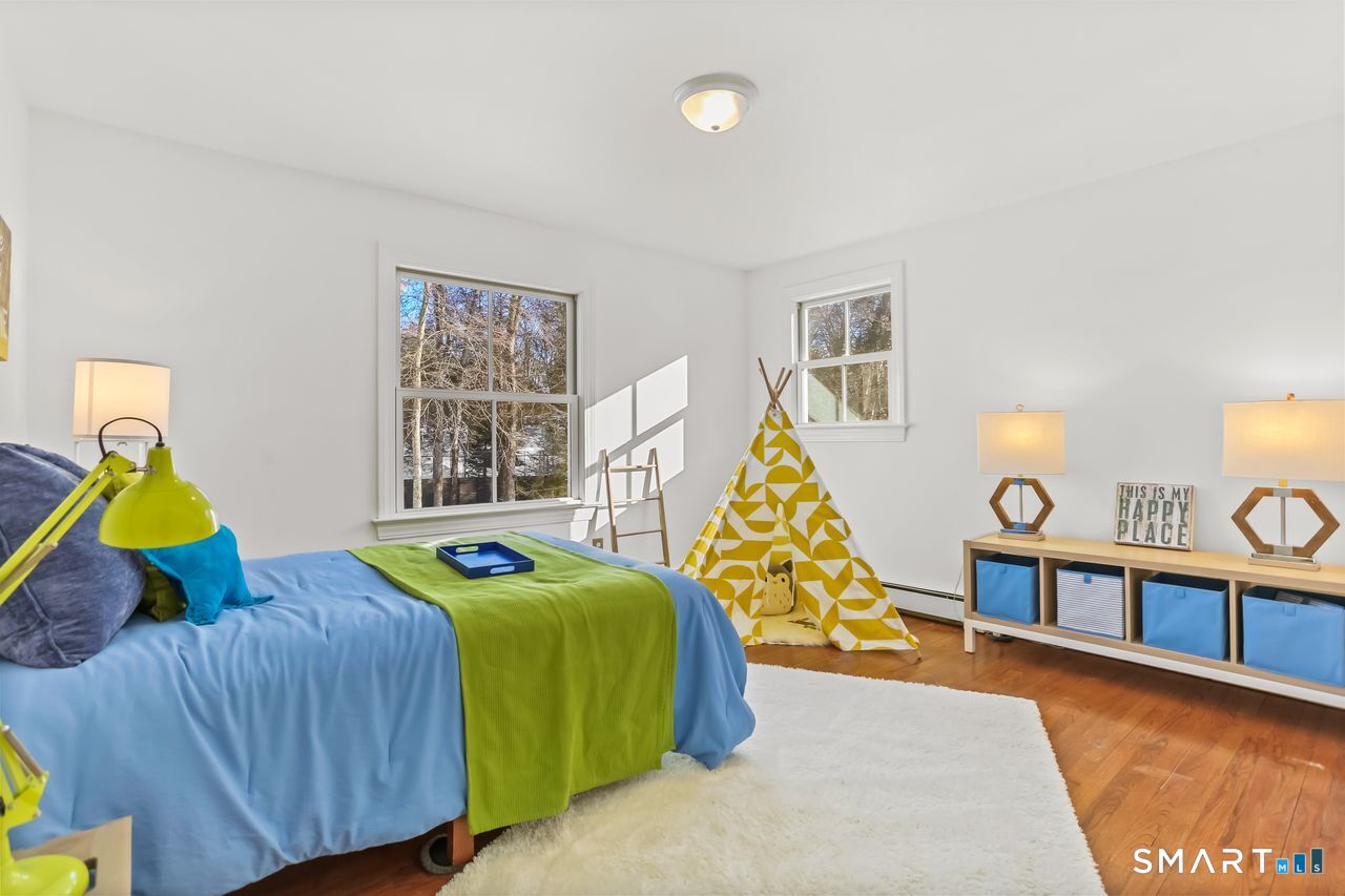 103 Davis Hill Road Weston, CT 06883 - Photo 25 of 37 a bedroom with two beds and a window