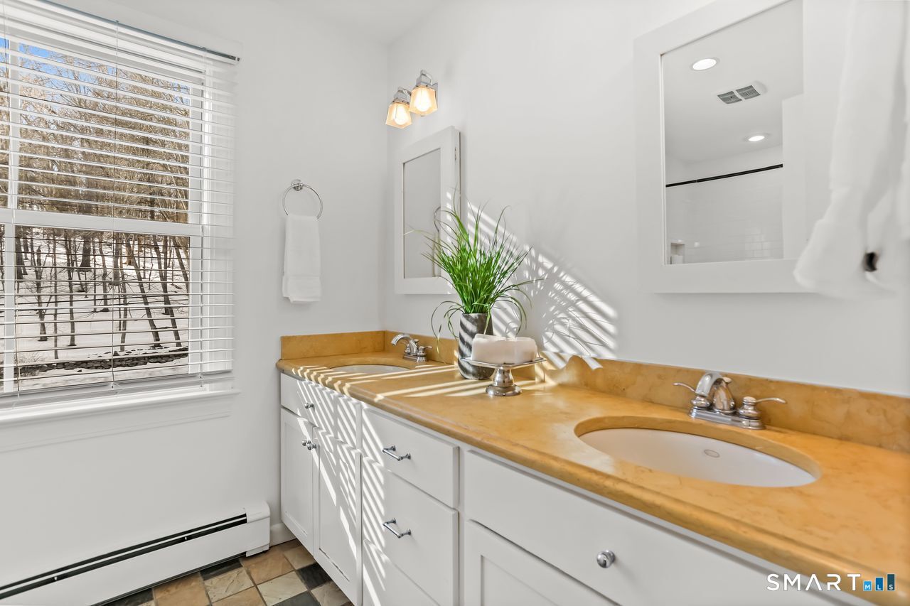 103 Davis Hill Road Weston, CT 06883 - Photo 26 of 37 a bathroom with a granite countertop sink and a mirror