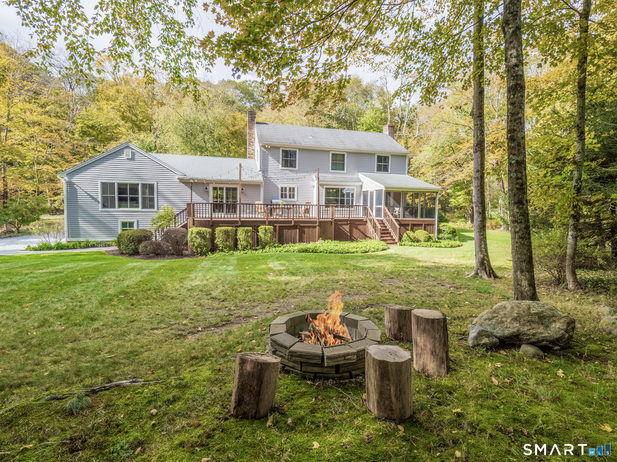 103 Davis Hill Road Weston, CT 06883 - Photo 35 of 37 a view of a house with backyard sitting area and garden
