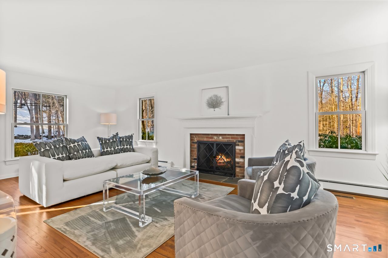 103 Davis Hill Road Weston, CT 06883 - Photo 5 of 37 a living room with furniture and a fireplace