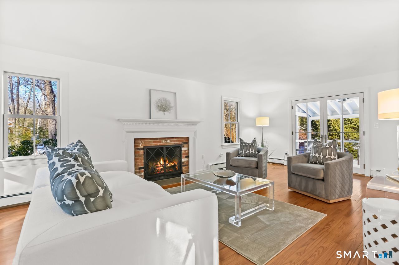 103 Davis Hill Road Weston, CT 06883 - Photo 6 of 37 a living room with furniture and a fireplace