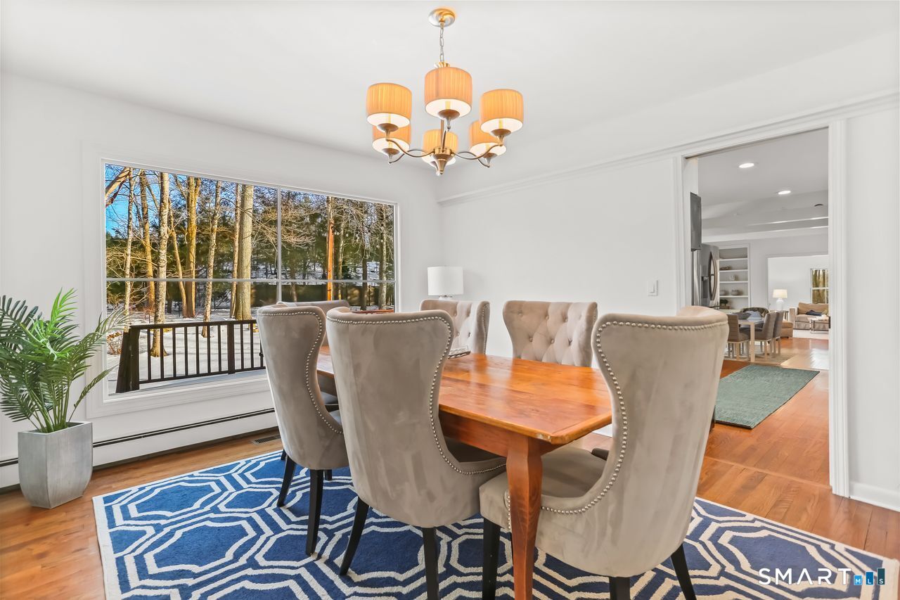 103 Davis Hill Road Weston, CT 06883 - Photo 8 of 37 a view of a dining room with furniture wooden floor and a chandelier