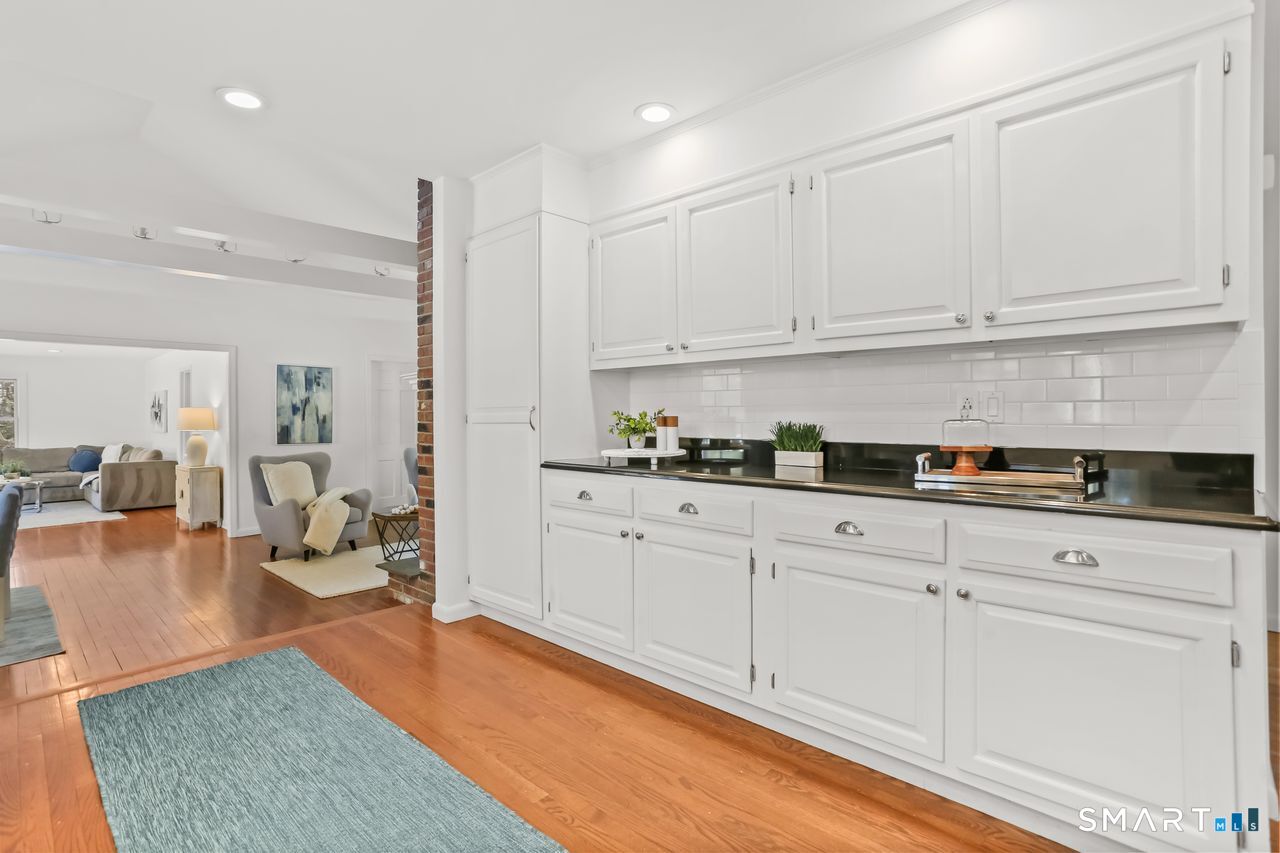 103 Davis Hill Road Weston, CT 06883 - Photo 10 of 37 a kitchen with stainless steel appliances granite countertop a refrigerator sink and white cabinets