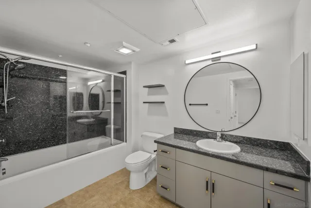 a bathroom with a shower and a sink