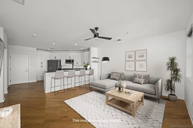 a living room with furniture and view of kitchen