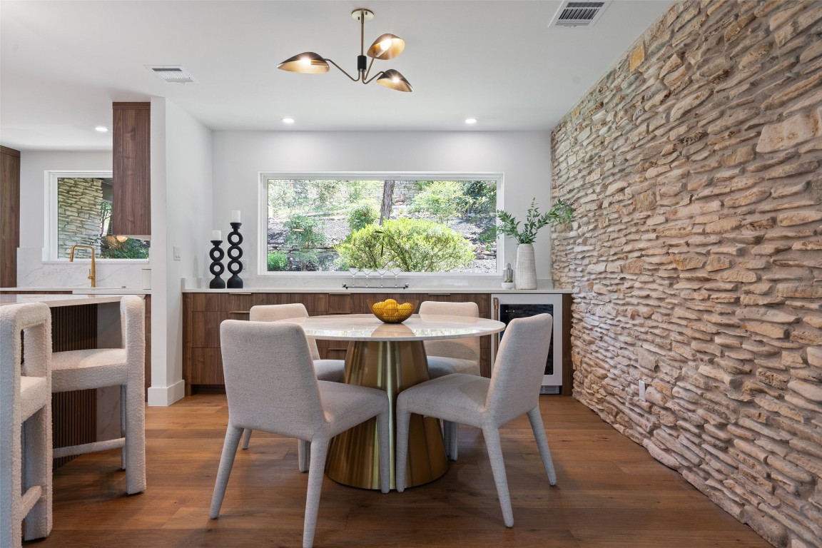 3403 Cascadera Drive Austin, TX 78731 - Photo 19 of 38 a dining room with furniture a window and a fireplace