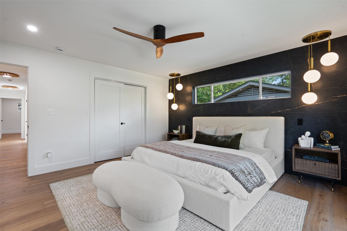 3403 Cascadera Drive Austin, TX 78731 - Photo 25 of 38 a bedroom with a bed and a chandelier