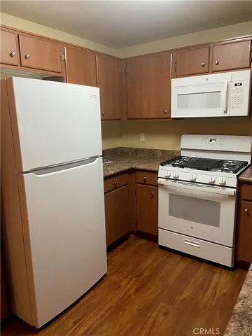 a white refrigerator freezer sitting in a kitchen