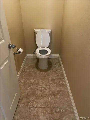 a white toilet sitting in a bathroom