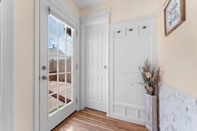 a view of a hallway with wooden floor and closet
