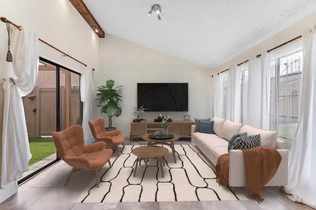 a living room with furniture fireplace and a flat screen tv