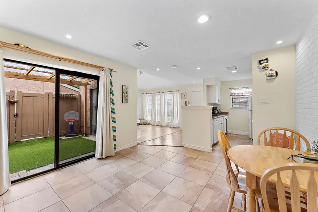 a open kitchen with stainless steel appliances granite countertop a refrigerator and a sink
