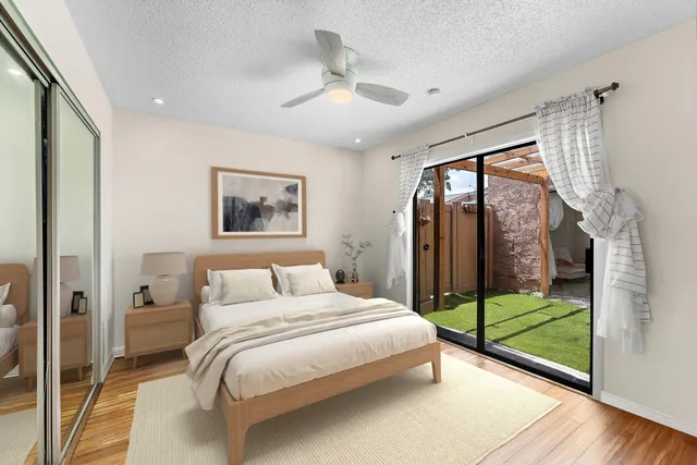 a bedroom with a bed and a large window