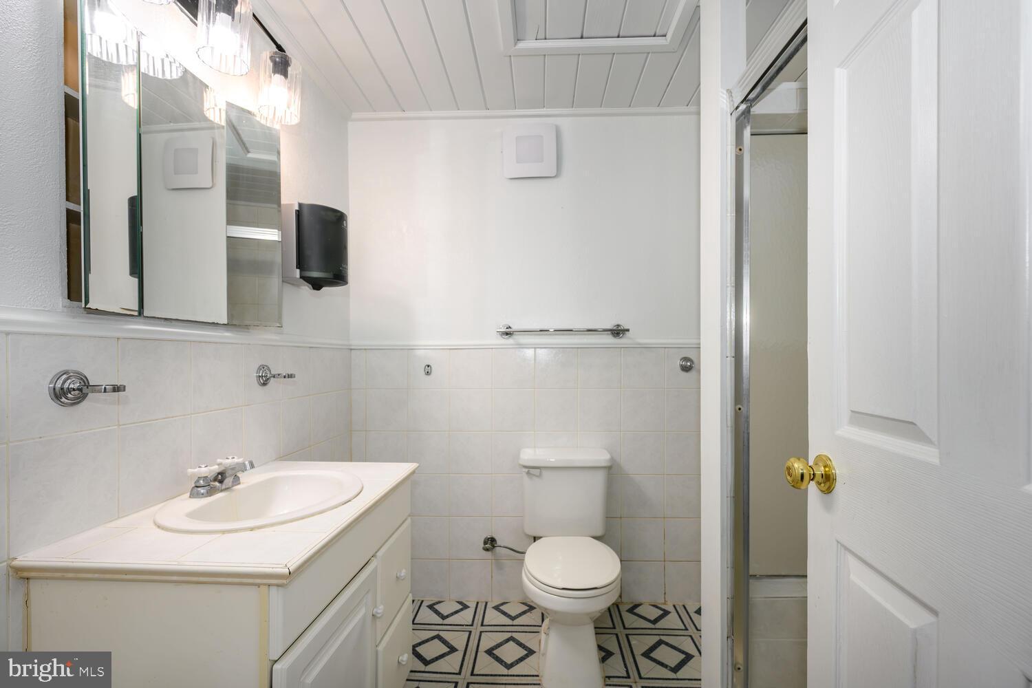 6746 Quaker Neck Road Chestertown, MD 21620 - Photo 32 of 50 a bathroom with a sink toilet and mirror