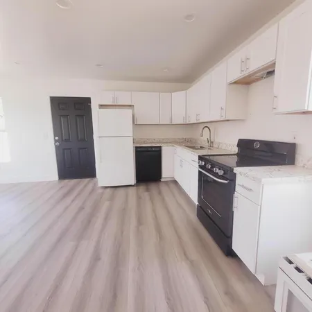 a kitchen with a sink and a stove top oven