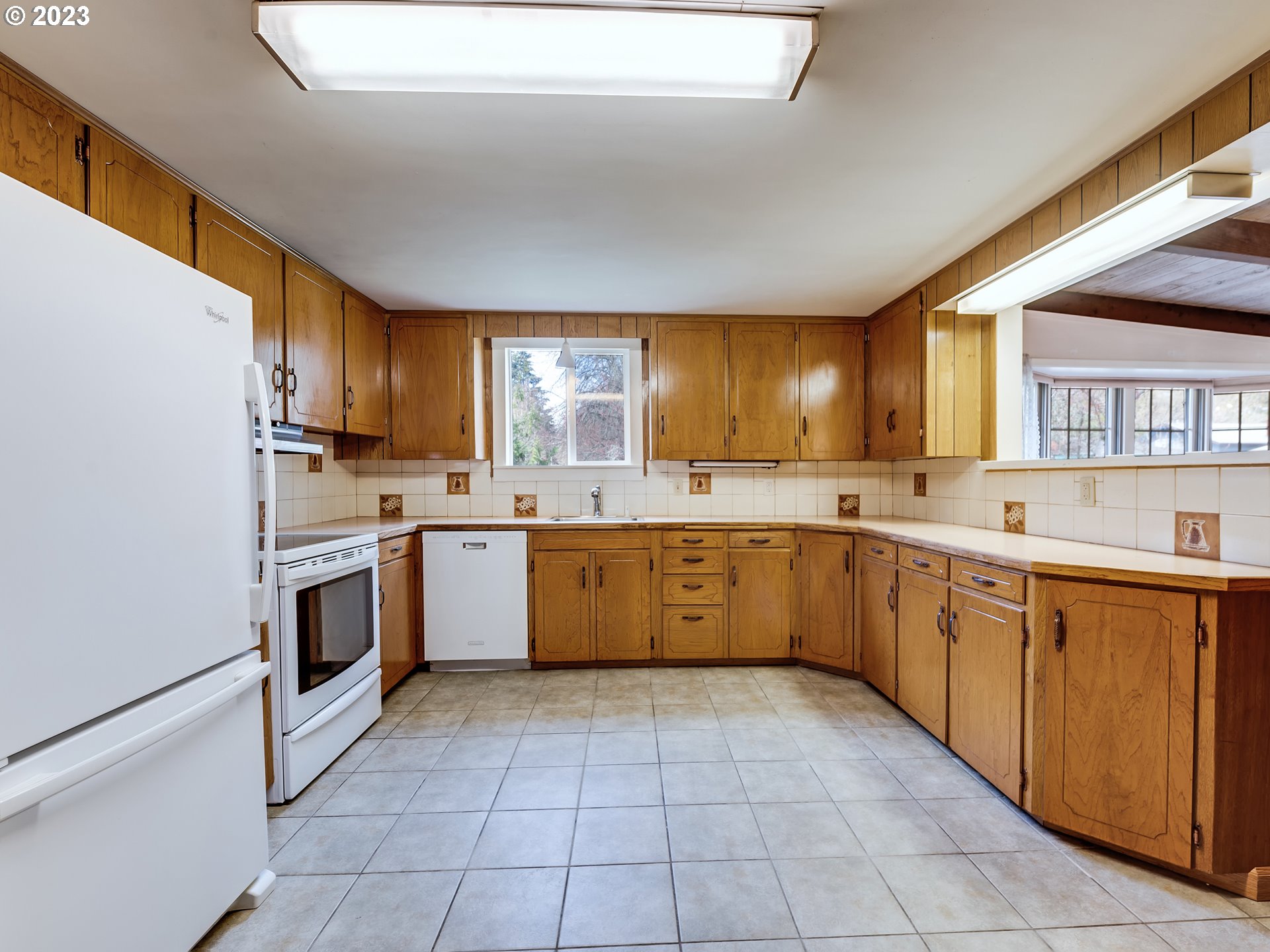 176 West C Street Springfield, OR 97477 - Photo 11 of 42 a large kitchen with a stove top oven sink and cabinets