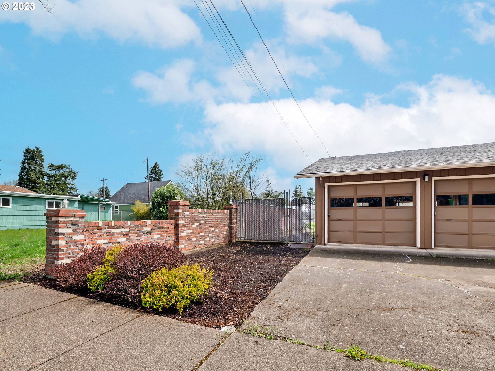 176 West C Street Springfield, OR 97477 - Photo 40 of 42 a front view of a house with a yard and garage