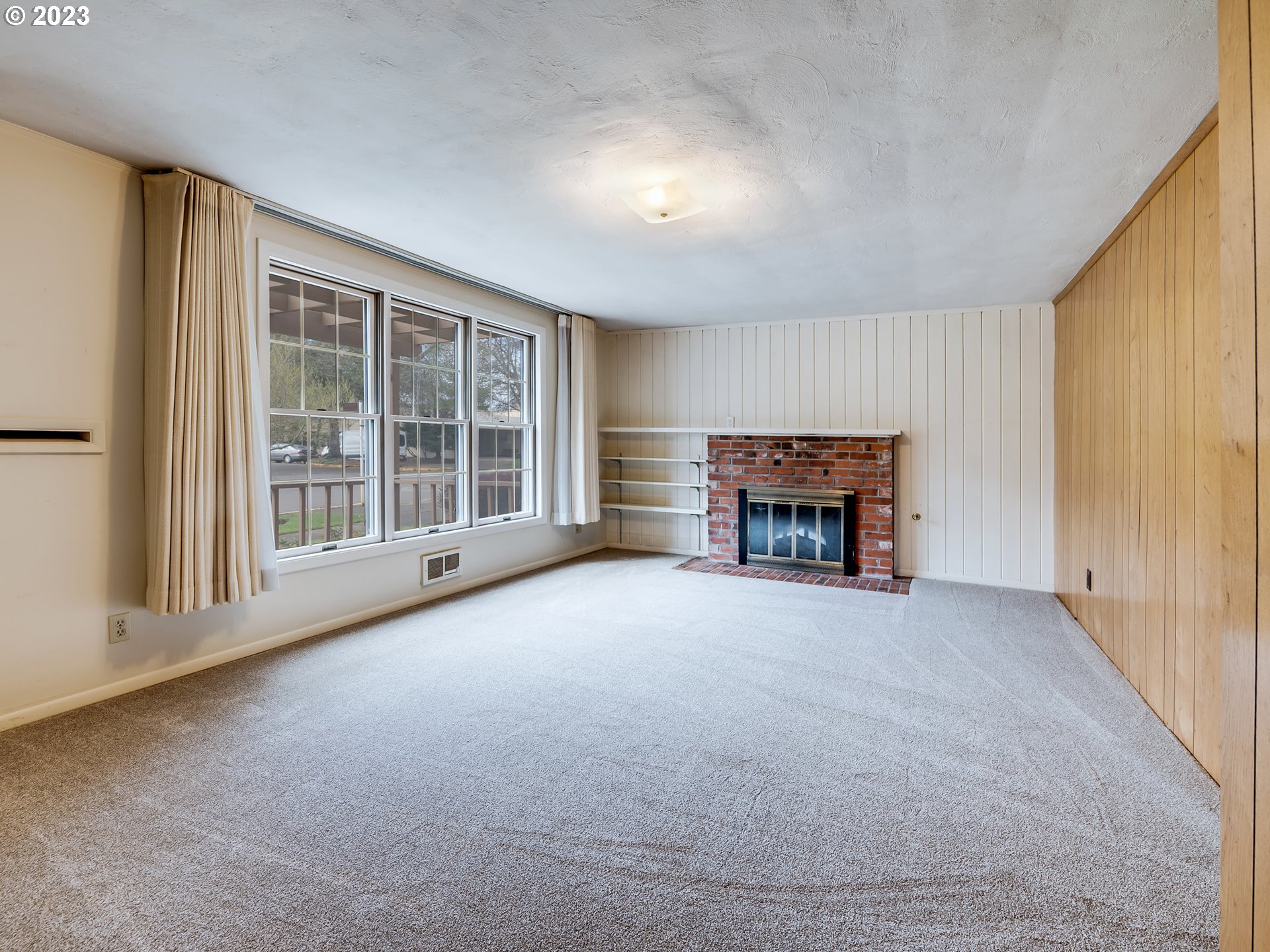 176 West C Street Springfield, OR 97477 - Photo 7 of 42 an empty room with furniture and a fireplace