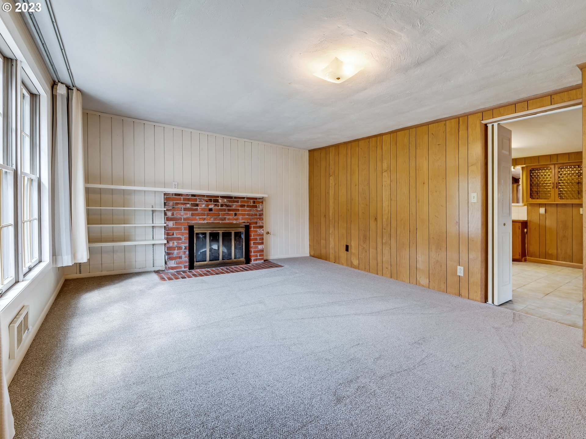 176 West C Street Springfield, OR 97477 - Photo 8 of 42 an empty room with fireplace and windows
