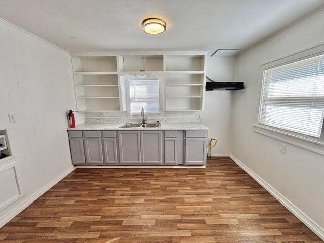 420 West Lynn Street Slaton, TX 79364 - Photo 11 of 25 a view of a kitchen with cabinets and wooden floor