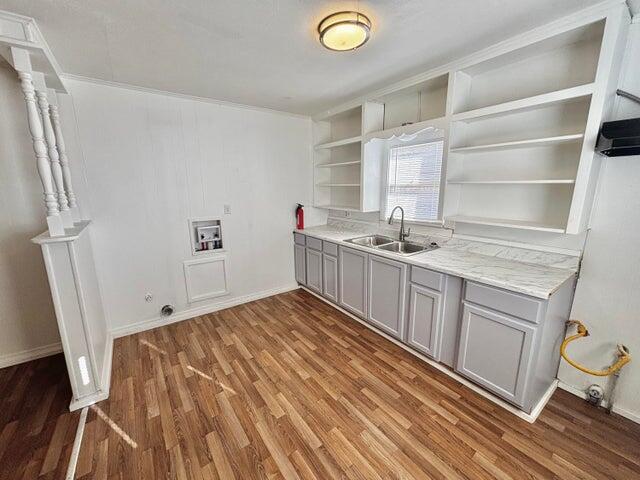 420 West Lynn Street Slaton, TX 79364 - Photo 12 of 25 a kitchen with a sink a stove cabinets and wooden floor