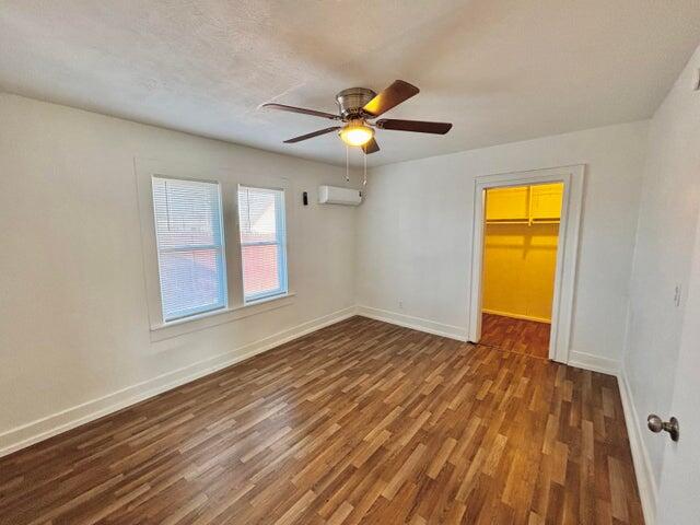 420 West Lynn Street Slaton, TX 79364 - Photo 15 of 25 a view of empty room with wooden floor and fan