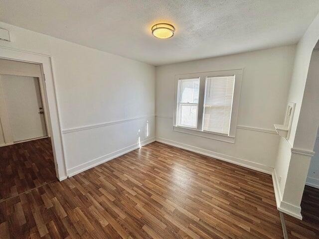 420 West Lynn Street Slaton, TX 79364 - Photo 7 of 25 a view of empty room with wooden floor and window