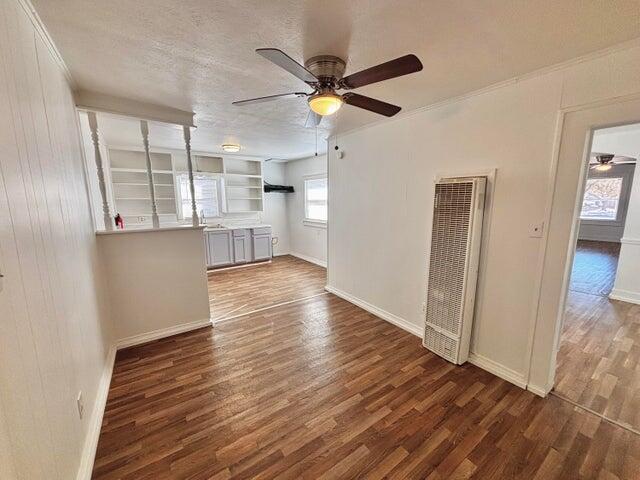 420 West Lynn Street Slaton, TX 79364 - Photo 10 of 25 a view of empty room with wooden floor and window