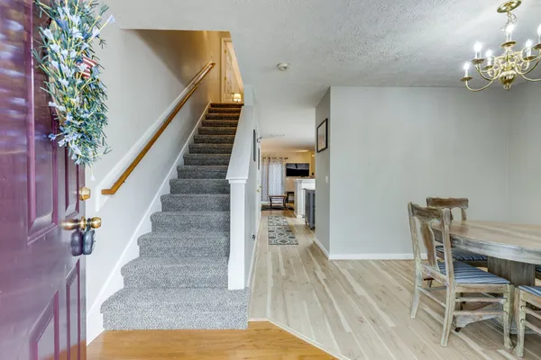 a view of entryway and hall with wooden floor