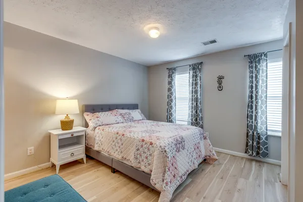 a bedroom with a bed and a window