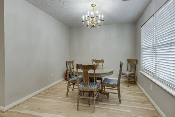 a dining room with furniture and wooden floor