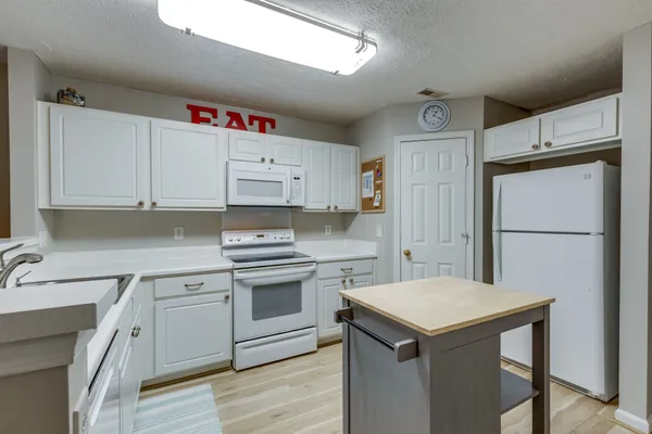 a kitchen with a table and chairs in it