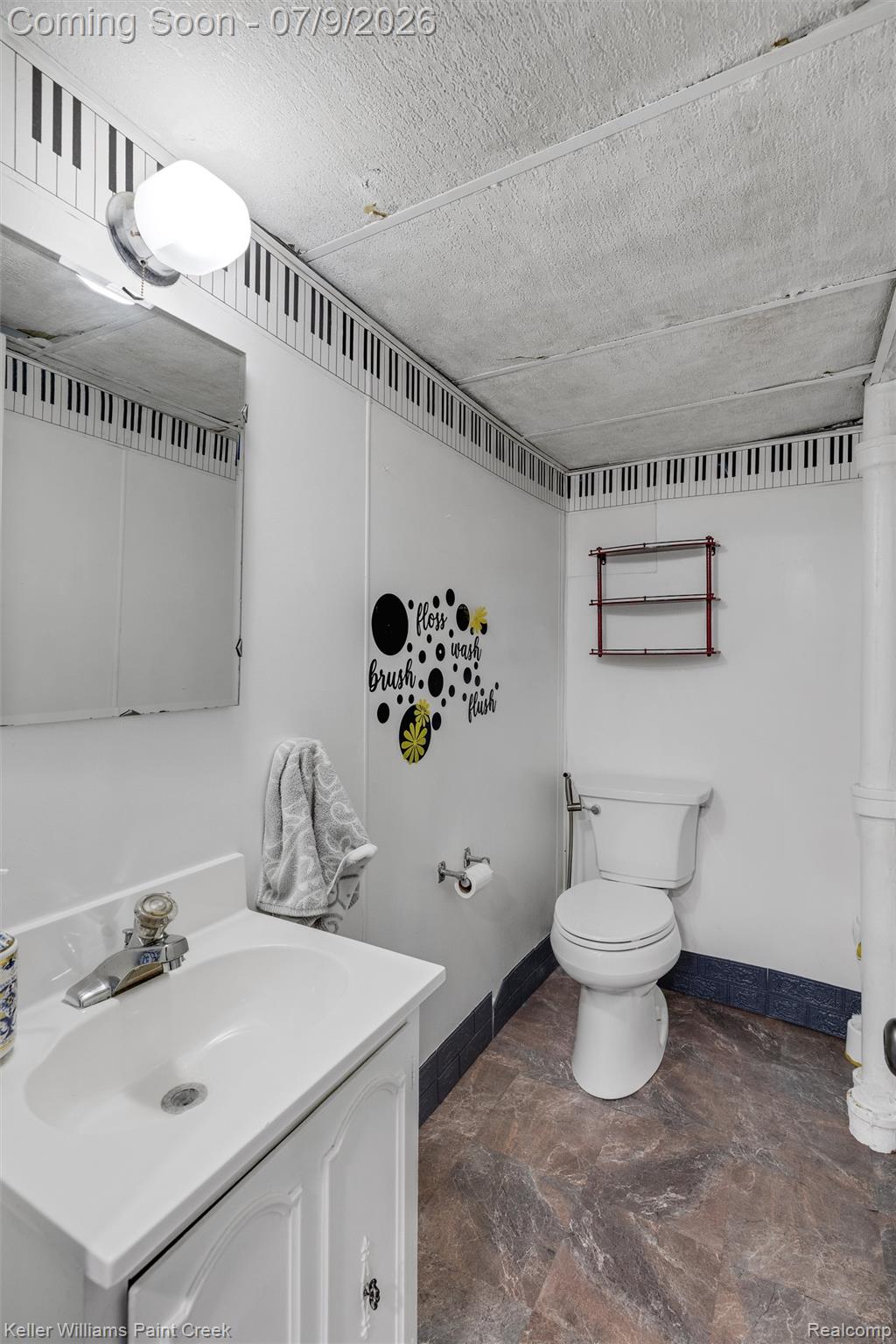 2731 Crooks Road Royal Oak, MI 48073 - Photo 25 of 34 Bathroom featuring a white vanity with integrated sink, chrome faucet, and a wall-mounted mirror