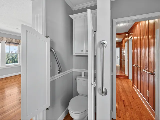 a view of a room with a window and a ceiling fan