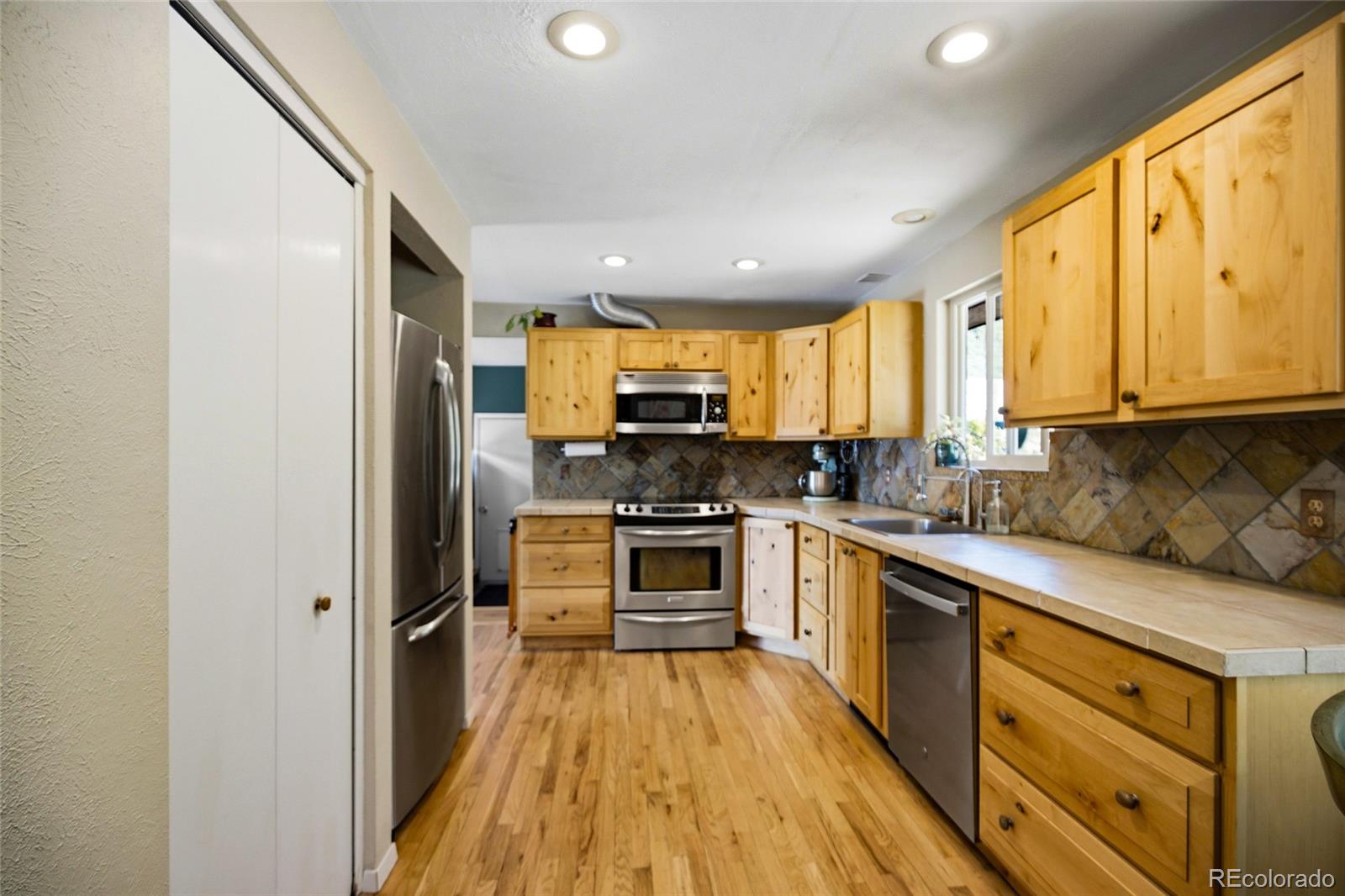 31280 Florence Road Conifer, CO 80433 - Photo 15 of 48 a kitchen with stainless steel appliances granite countertop a stove and a refrigerator
