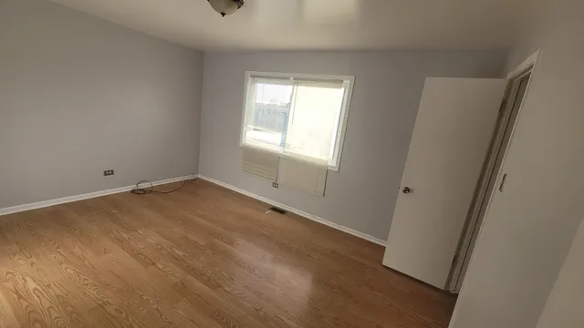 wooden floor and window in an empty room