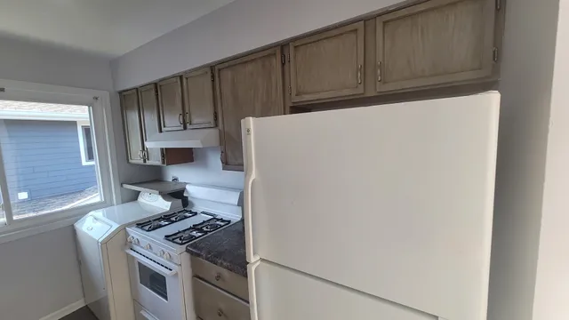 a kitchen with a stove and a refrigerator