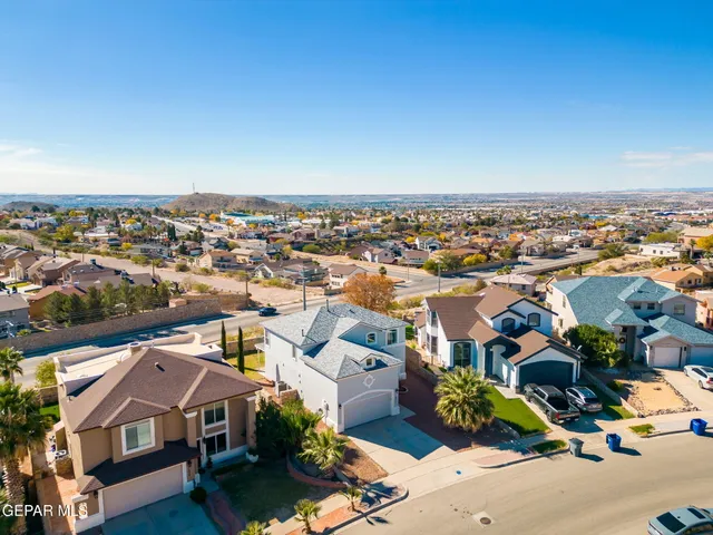 an aerial view of residential houses with a city