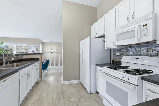 a kitchen with cabinets appliances and a counter space