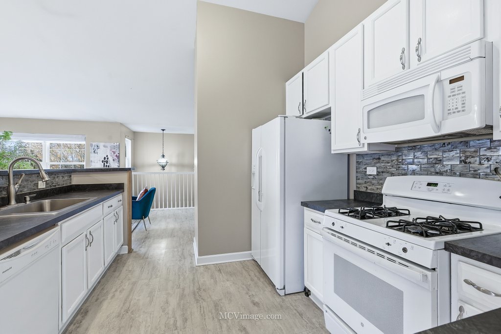2460 Golf Ridge Circle, Unit 2460 Naperville, IL 60563 - Photo 12 of 25 a kitchen with cabinets appliances and a counter space