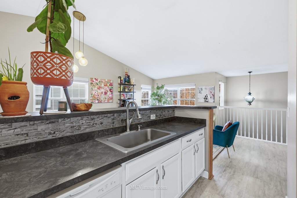 2460 Golf Ridge Circle, Unit 2460 Naperville, IL 60563 - Photo 13 of 25 a kitchen with stainless steel appliances granite countertop a sink a stove and a wooden floor