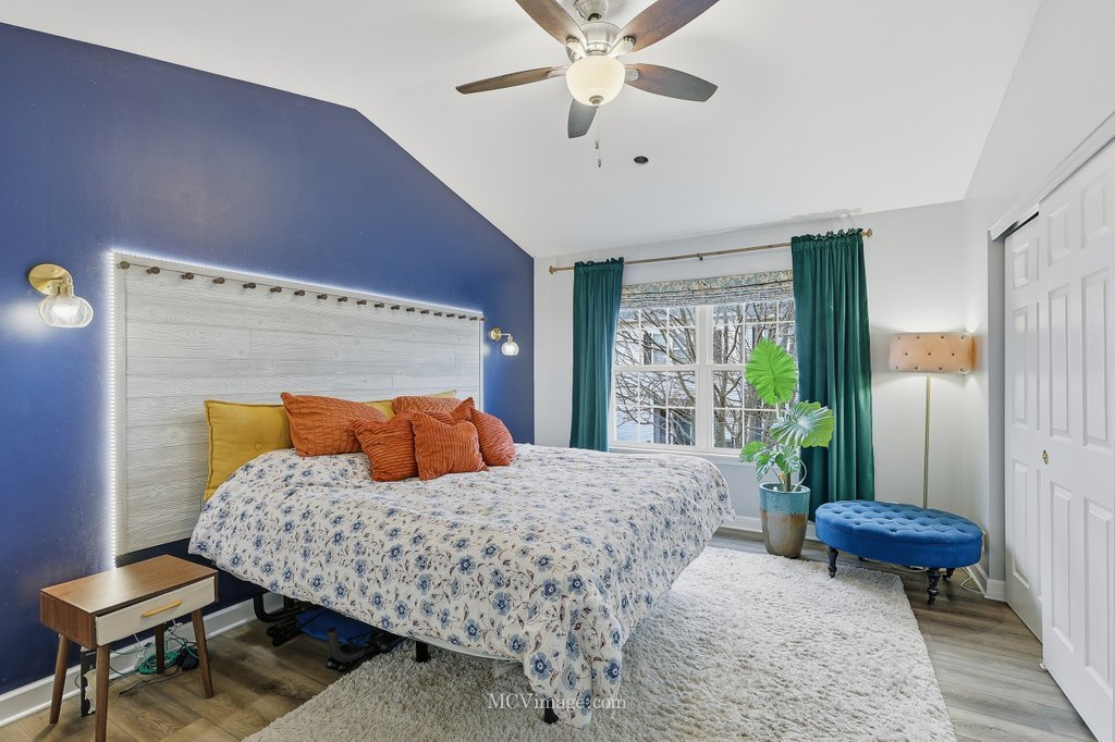 2460 Golf Ridge Circle, Unit 2460 Naperville, IL 60563 - Photo 19 of 25 a bedroom with a bed and a chandelier