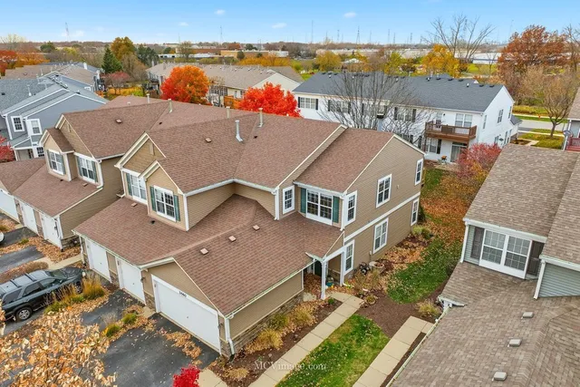 an aerial view of multiple houses with a yard