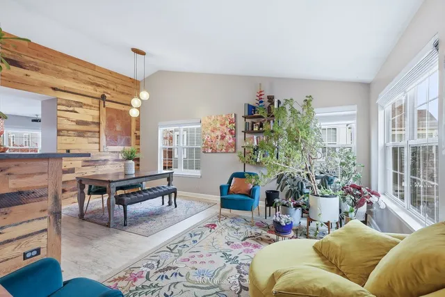 a living room with furniture and flowers
