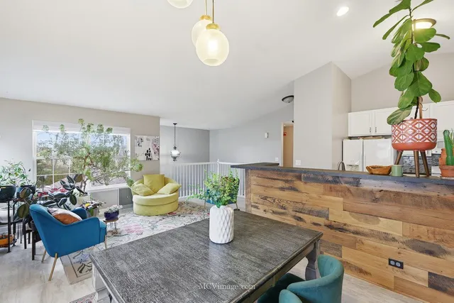 a living room with furniture flowerpot and window