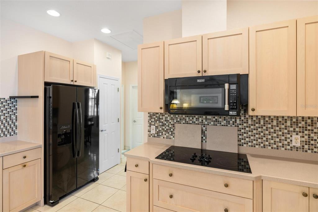 8069 Southwest Aviary Road Arcadia, FL 34269 - Photo 17 of 60 a kitchen with granite countertop a refrigerator and a sink