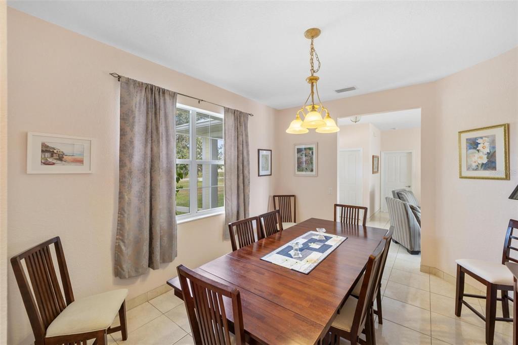 8069 Southwest Aviary Road Arcadia, FL 34269 - Photo 22 of 60 a view of a dining room with furniture window and wooden floor