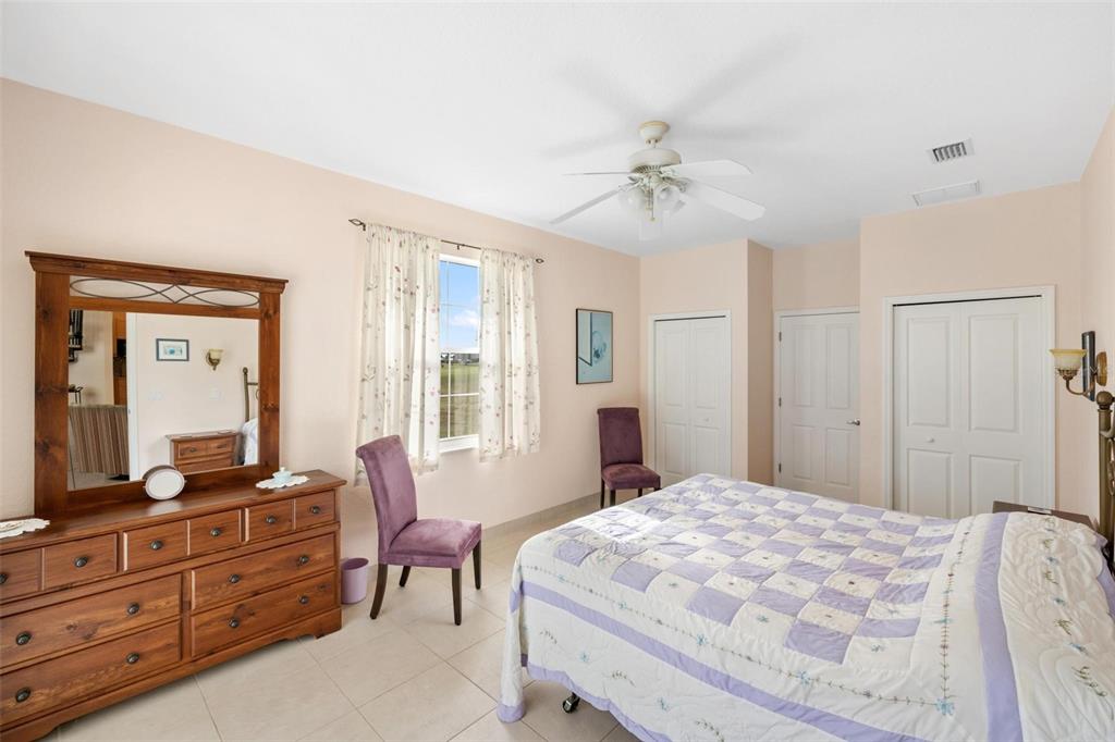 8069 Southwest Aviary Road Arcadia, FL 34269 - Photo 30 of 60 a spacious bedroom with a large bed and a dresser